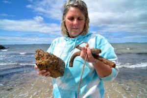 Altona beachgoers swimming against the rubble