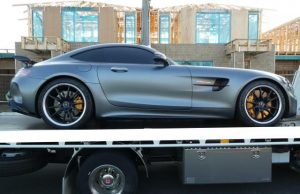 Police charge Altona man with fraud offence and seize luxury cars